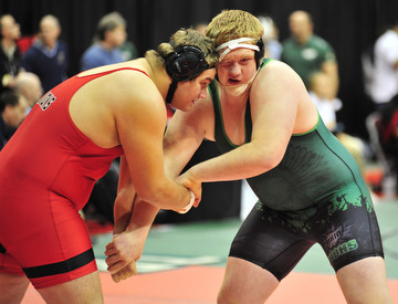 West Branch's Connor Sharp butts heads with New Richmond's J.R. Sharp.