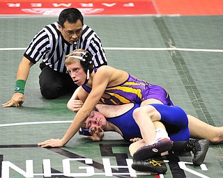 Poland's Dante Ginnetti attempts to avoid being pinned by Eaton's Michael May.
