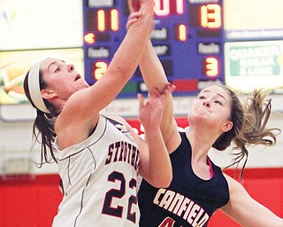 Struthers’ Brittaney Zupko (22) tries to shoot over Canfield’s Sabrina Mangapora (44) during the Division II district semifinal Thursday at Austintown Fitch High School. The Cardinals bested the Wildcats, 61-54.