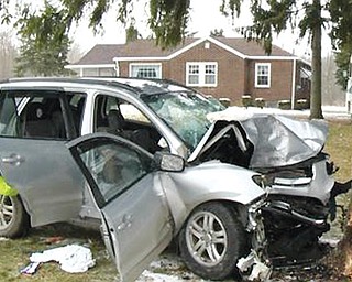 This Hyundai Sante Fe sport-utility vehicle crashed into a tree on New Castle Road in Poland Township on Sunday
afternoon, killing two and seriously injuring one.