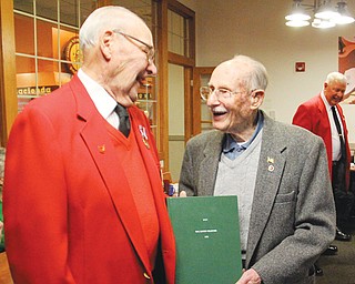 Sgt. Paul Sovik of Youngstown gives Raymond Braidich a book as a present during a birthday celebration for Braidich, 95, at the Golden Corral restaurant in Boardman last week.
