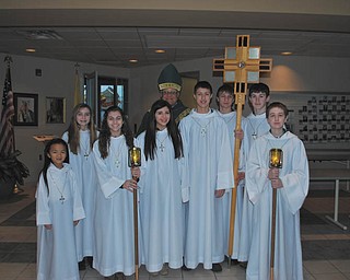 SPECIAL TO THE VINDICATOR
Bishop George Murry of the Diocese of Youngstown poses with altar servers recently before a Mass at Holy Family Church in observance of Catholic Schools Week. Pictured are, from left, Margaret Faur, Hannah Frisone, Morgan Wardle, Emilee Mulhall, Bishop Murry, Christopher Perry, Anthony Zeno, Patrick Brennan and Robert Kurta.