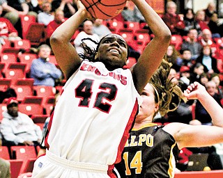 Youngstown State’s Brandi Brown (42) gets past Valparaiso’s Tabitha Gerardot (14) on her way to a layup Monday night at Beeghly Center. Brown scored 18 points in the Penguins’ 72-50 victory. Brown reached the 2,000-point milestone for her career at YSU.