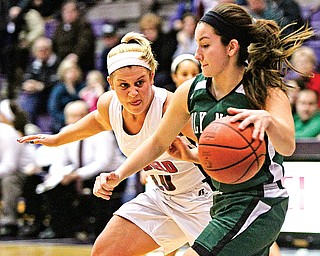 Canfield’s Paige Baker (10) keeps a close watch on Holy Name’s Rachael Kucharcyzk (33) during the Division II regional semifinal Tuesday at Barberton High School. The Cardinals downed the Green Wave, 52-30.