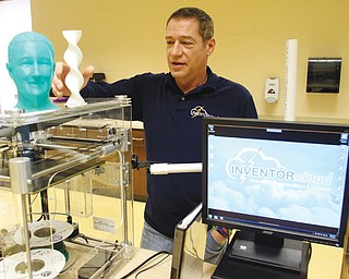 Mark Baka, Stprm Lab Mgr, shows items students made using 3dprinter and additive manufacturing process.