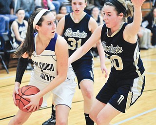 Maplewood’s Allison Bell (10) looks to pass after grabbing a rebound away from Lowellville’s Maddie Opritza (30) and Rachel Durbin (31). Maplewood won to advance to Saturday’s game against Berlin Hiland.