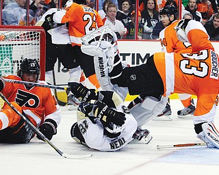 Philadelphia Flyers’ Scott Hartnell, left, and Pittsburgh Penguins’ James Neal collide with goalie Brian Boucher and slide into the net during the third period of a game Thursday in Philadelphia. The Penguins won 5-4.