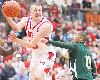 LaBrae’s Peyton Aldridge (10) passes over Ursuline’s Desmond McElroy (0) during the Vikings’ 68-61 double-overtime win for the Division III district title Saturday at Howland. Cardinal Mooney and Youngstown Christian also advance to regional play this week in Canton after winning their districts — Division II and IV, respectively — over the weekend.
