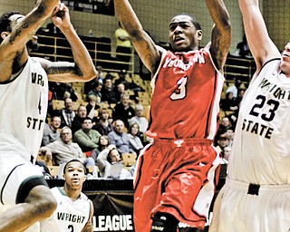 Youngstown State’s Kendrick Perry (3) drives against Wright State’s Jerran Young (4) and A.J. Pacher (23) during a Horizon League tournament game Friday at Valparaiso. The Penguins lost, 66-59, but Perry and his teammates aren’t finished. YSU has accepted a bid to the CollegeInsider.com tournament.