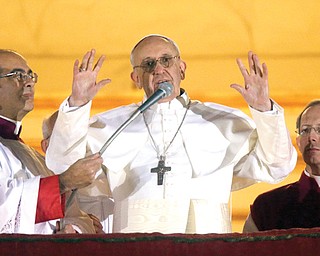 Pope Francis waves to the crowd from the central balcony of St. Peter’s Basilica at the Vatican on Wednesday. Cardinal Jorge Bergoglio, who chose the name of Francis, is the 266th pontiff of the Roman Catholic Church.