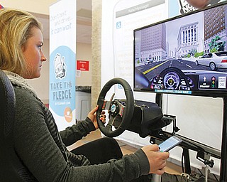 Rachel Wyand, a senior at Canfield High School, goes through the texting and driving simulator during AT&T’s “It Can Wait” program. The program, attended by local law enforcement and county officials, coincided with the enactment of Ohio’s texting ban March 1.