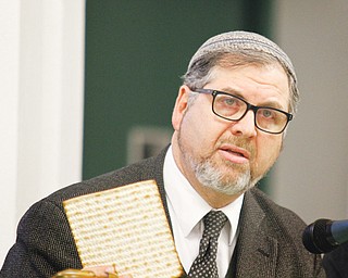 Rabbi Joseph Schonberger of Temple El Emeth in Liberty breaks the matzah during Wednesday night’s Seder at St. Patrick Church in Youngstown. The event, sponsored by Generations of Faith, was a learning experience about the ritual meal.