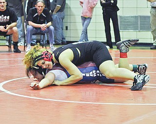 Corri Sayre, top, who gets to pin boys as a member of the Howland junior varsity wrestling team, will be wrestling girls this weekend at the United States Girls Wrestling Association national championships at Eastern Michigan University.