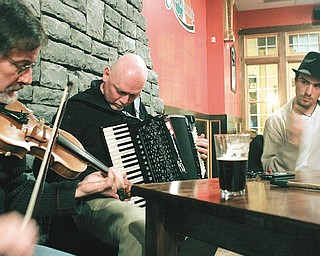 Frank Krygowski , Mike Shaffer and John Vitullo play during an traditional Irish music jam session or “sessiun” at a downtown Youngstown pub.