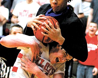 Youngstown Christian’s KaeVon Green (24) pulls down a rebound along with Hannibal River defender Brett Price (21) during the Division IV regional semifinal Tuesday at Canton Memorial Fieldhouse. The Eagles downed the Pilots, 60-49, to advance to the final today against Villa Angela-Saint Joseph. Tip-off is set for 7:30 p.m.