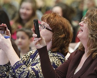 ROBERT  K.  YOSAY  | THE VINDICATOR --..Making Memories -- Andrea McKenna and Keli Bellas  record the moment  of  Cole McKenna of Struthers Elementary (sisters)..The 80th  Youngstown Vindicator Spelling Bee was held at Kilcawley Center on YSU Campus  Saturday morning with  60 competitors from area schools.. ..(AP Photo/The Vindicator, Robert K. Yosay)
