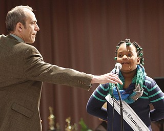 ROBERT  K.  YOSAY  | THE VINDICATOR --..Tim Roberts -  adjusts the microphone for Bryona Colyar - of 2nd grader at Williamson Elementary..The 80th  Youngstown Vindicator Spelling Bee was held at Kilcawley Center on YSU Campus  Saturday morning with  60 competitors from area schools.. ..(AP Photo/The Vindicator, Robert K. Yosay)