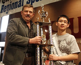 ROBERT  K.  YOSAY  | THE VINDICATOR --..Pronouncer Fred Owens PHD  - awards the Champion Trophy - to Max Lee - ..The 80th  Youngstown Vindicator Spelling Bee was held at Kilcawley Center on YSU Campus  Saturday morning with  60 competitors from area schools.. ..(AP Photo/The Vindicator, Robert K. Yosay)