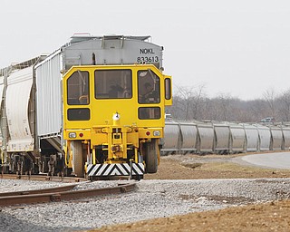 A Mobile Track Rail Car Moover moves some of the dozen railroad cars with sand  at the BTR Buckeye Transfer Realty -  new transhipment facility in Columbiana is processing 2,000 tons-per-day of fracking sand for use at regional wells. In the last month, the facility has added 20 jobs just to handle the shipments it takes in from large freight trucks  41738 Esterly Drive, Columbiana.

