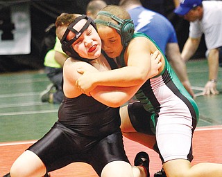 Columbiana’s Andrew Stallsmith, left, grapples with Tyler Knight in the 120-pound weight division of the Ohio Athletic Conference grade school wrestling championships on Sunday at the Covelli Centre. Andrew lost the match but metaled.