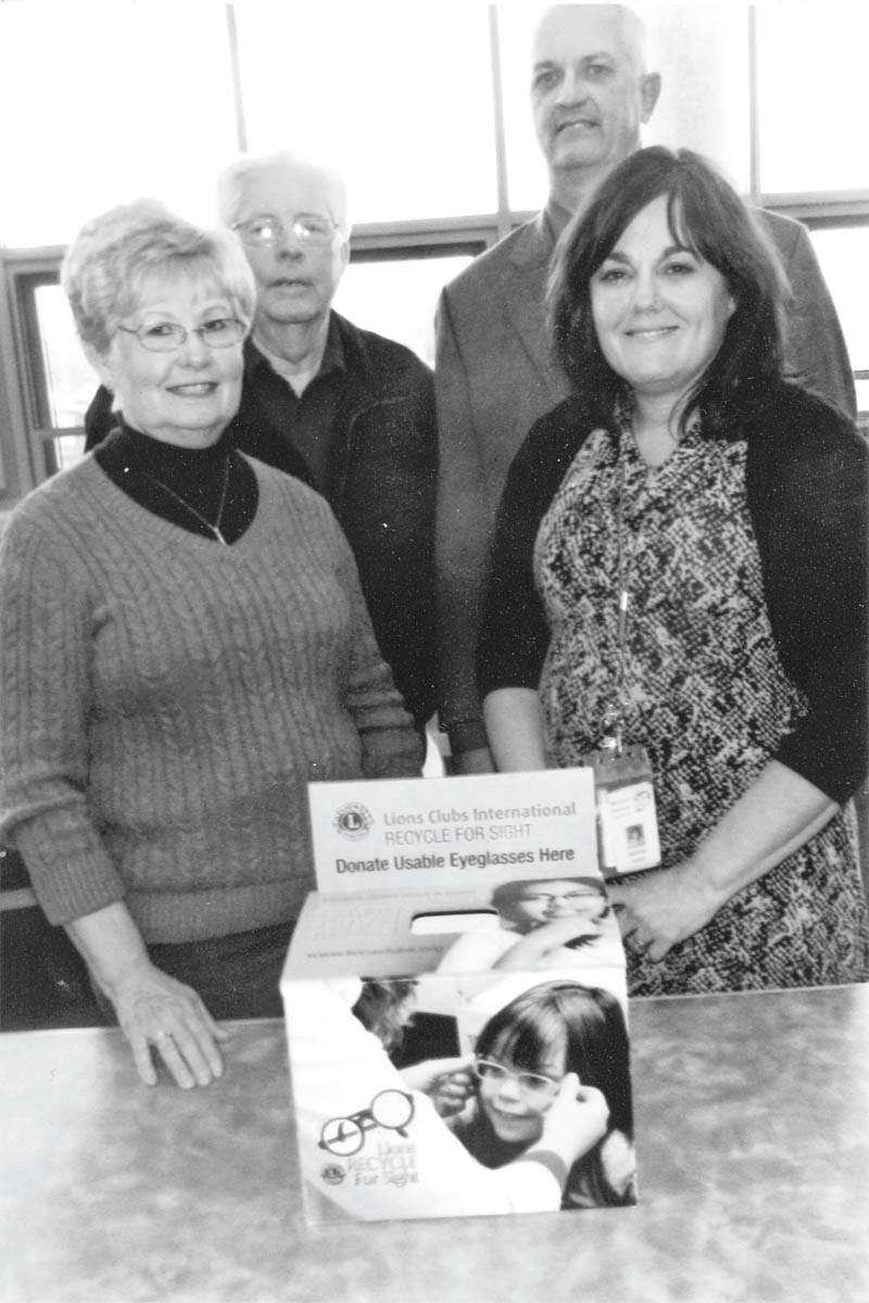 SPECIAL TO THE VINDICATOR
The new West Mahoning County Lions Club recently placed an eyeglass deposit box in the library at Western Reserve School, 13850 W. Akron-Canfield Road, Berlin Center. In front, from left, are Shirley Boyles, club member; Debbie Farelli, club member and principal of the elementary and middle schools; in back are Randy Boyles, club member; and Jeff Zatchok, superintendent and principal of the school. Glasses collected by the students and faculty will give the gift of sight to the needy in Central and South American countries. The club meets at 6 p.m. today at Dino’s Restaurant in North Jackson. Residents of Berlin Center, Ellsworth and North Jackson are eligible for membership. For information contact Bob Whited at 330-792-7907 or olebert1@aol.com.
