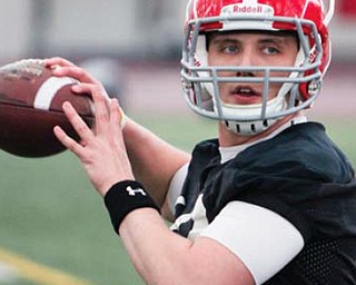 Youngstown State quarterback Kurt Hess looks downfield during a passing drill Tuesday. The workout was the first of the spring for YSU.