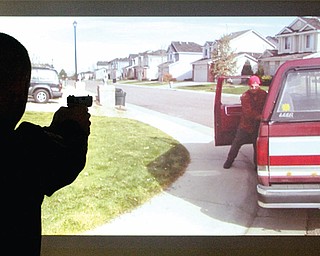 Hubbard Police Dept ptlm Brian Horne takes aim during a firearms training simualtion at the Police Dept Tuesday 3-19-13.