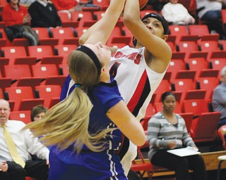 Youngstown State’s Shar’Rae Davis (4) goes for a jump shot against Indiana State defender Natasha Zurek during their game Thursday during Round 1 of the WNIT at YSU’s Beeghly Center. The Penguins cut down the Sycamores, 63-51.