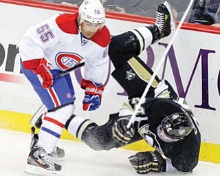 Montreal Canadiens defenseman Francis Bouillon (55) collides with Pittsburgh Penguins left wing Matt Cooke (24) in the ﬁ rst period of an NHL hockey game in Pittsburgh on Tuesday.