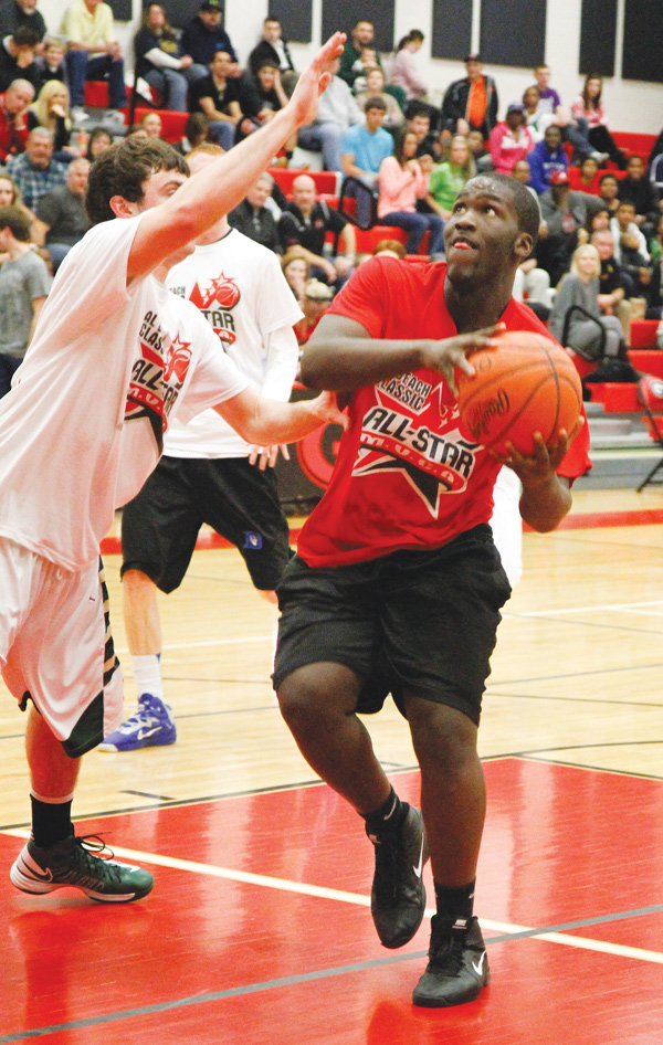 East’s Deontay Scott shoots the ball for the Red Team against the White Team’s defender Ryan Strollo of Ursuline during the boys’ game at the Al Beach classic. Red downed White, 75-61, and Scott earned MVP honors.