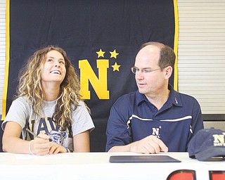 Canfield’s Allison Pavlansky signs a letter of intent to attend the U.S. Naval Academy as her father and the team’s coach, Pat Pavlansky, watches during a ceremony Thursday at Canfield High School. Pavlansky will play tennis for the Midshipmen. A four-time most valuable player for the Cardinals, she is the reigning two-time All-American Conference player of the year and helped the Cardinals to four consecutive American Division crowns.