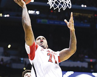 Louisville’s Chane Behanan (21) lays the ball up during the first half of the Midwest Regional final against Duke in the NCAA college basketball tournament Sunday in Indianapolis.