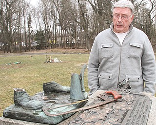 Gary Pollock, cemetery overseer at Mahoning Valley Memorial Park in Youngstown, looks over a monument
where a military statue was sawed off with hacksaw last week. Police made an arrest in the theft Monday.