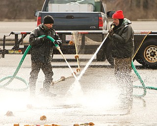 Ohio Department of Natural Resources workers Matt Wolfe, left, and Steve Moss didn’t have too much fun in the cold Monday cleaning nets used this weekend to catch walleye eggs for hatching. Last month was colder with more snow than a typical March for the area, and the start of April wasn’t any better.