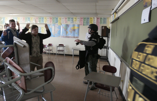            ROBERT K. YOSAY  | THE VINDICATOR..Officers empty a classroom after student barricaded themselves in the room - ..BPD and area law enforcement had a mock drill of a shooter at Boardman High School - .. - -30-..