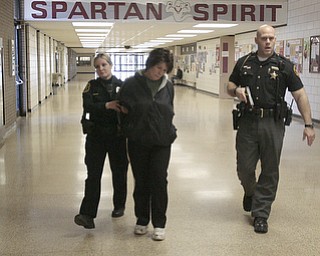 ROBERT K. YOSAY | THE VINDICATOR..Ptl Heather Englert and Sheriff Deputy ---- walk one of the shooters from the building - .after discovering her in the school office..( BPD and area law enforcement had a mock drill of a shooter at Boardman High School - .. - -30-..