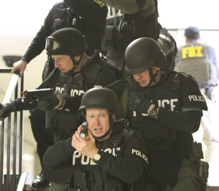            ROBERT K. YOSAY  | THE VINDICATOR..Sgt Mike Hughes  and Sgt Glen RIddle directly behind to the left come down a stairwell as they look for a possible shooter at BHS..BPD and area law enforcement had a mock drill of a shooter at Boardman High School - .. - -30-..