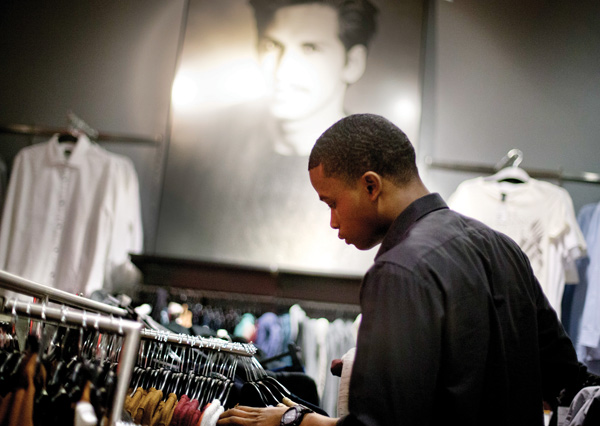Dominic Plummer of Atlanta shops in an H&M store in Atlanta. Americans have grown more cautious and disciplined in handling their money since the financial crisis struck in 2008, a survey by Fidelity Investments suggests.