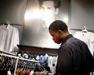 Dominic Plummer of Atlanta shops in an H&M store in Atlanta. Americans have grown more cautious and disciplined in handling their money since the financial crisis struck in 2008, a survey by Fidelity Investments suggests.