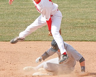 Youngstown State’s Phil Lipari (13) tags out Akron’s Kris Simonton (7) in a double play during the Penguins’
home opener Wednesday at Eastwood Field in Niles. YSU rallied but came up short, losing to the Zips, 5-4.
Canfield’s Jared Turocy accounted for four of Akron’s runs after hitting a two-run homer in the second and a sacrifice fly in the third.