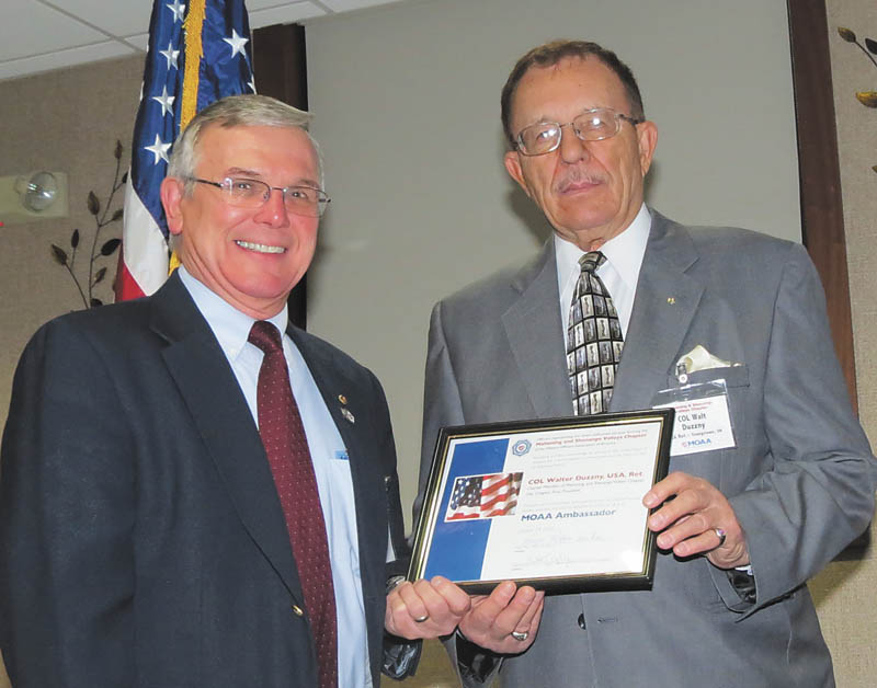 SPECIAL TO THE VINDICATOR
Col. Walter M. Duzzny, U.S. Army retired, right, receives the Military Officers Association of America Ambassador Award from Lt. Col. Michael Wisniewski, U.S. Army retired, at a recent recognition awards ceremony at Consolidated Activities Center of the Youngstown Air Force Reserve Station in Vienna.