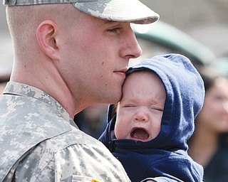 Pvt. Brandon Brown, with the 838th Military Police Co., shares a moment with his son Brandon Tyler Brown,
3 months. Brown was part of a “call to duty” ceremony Thursday at Old North Church in Canfield.