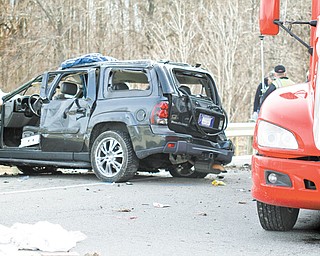 State troopers inspect the Chevrolet Trailblazer involved in Thursday morning’s crash on Interstate 76 in Milton Township that killed two young children and left their parents critically injured. The Trailblazer rolled several times, and the children and their mother were ejected.