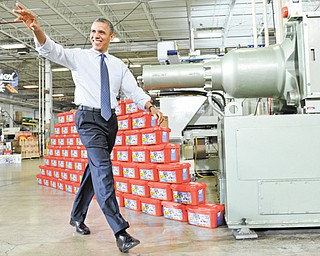 President Barack Obama waves as he arrives before speaking at the Rodon Group, which manufactures more than 95 percent of the parts for K’NEX Brands toys, in Hatfield, Pa.