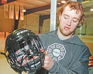 Youngstown Phantoms forward Cam Brown shows the caged helmet he wore in order to play in Saturday’s game
against Cedar Rapids. During Friday’s game with the RoughRiders, Brown lost a few teeth after being hit in the mouth by a puck that struck him just below his helmet visor.