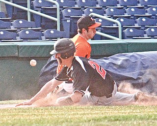 Canfield’s Jimmy Leone (21) knocks the ball loose after he collides with Howland’s Vinny Ruberto at third base during Monday’s game at Eastwood Field in Niles. The Tigers edged the Cardinals, 9-8.