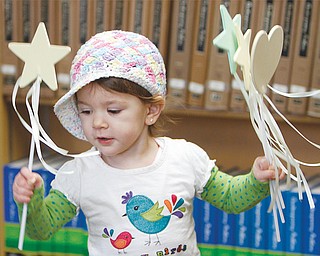 Katherine DePinto, 2, uses ribbons on stars and hearts as she dances to a song during the Gotta Move storytime at the Canfield library. Children age 2-5 joined for a variety of musical and movement activities that are designed to stimulate brain development and motivate language learning.