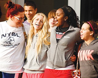 From left, Niles McKinley High School seniors Emily Estes, Danelle Cochran, Katrina Harris and Christina Vanormam sing the Niles fight song during ceremonies marking the opening of the new high school and the first official day of classes in the new building. The $27 million structure opened for classes Tuesday.