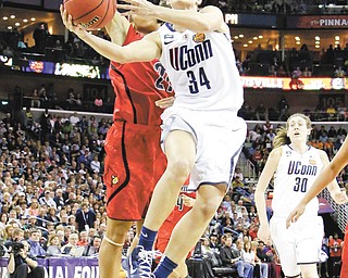 Connecticut guard Kelly Faris (34) goes up for a shot against Louisville guard Bria Smith during the second half of the NCAA women’s national championship game in New Orleans on Tuesday.