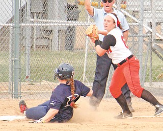 YSU’s Samantha Snodgrass (6) looks to throw to first base after tagging out Sarah Cupp (12) at third during the
first game of a doubleheader on Tuesday at McCune Park in Canfield. The Penguins won the first game, 5-0. Detroit took the second, 4-2.